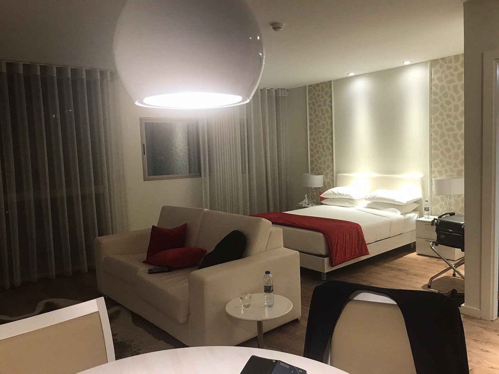 Spacious guest room with a sitting area and a double bed